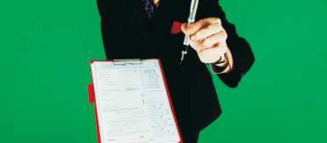 Portrait of a Market Researcher Holding a Fountain Pen and a Questionnaire